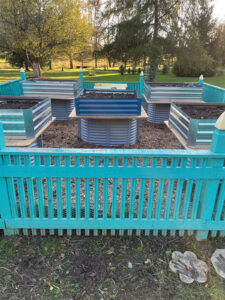 planters sitting on top of window wells inside fenced-in garden